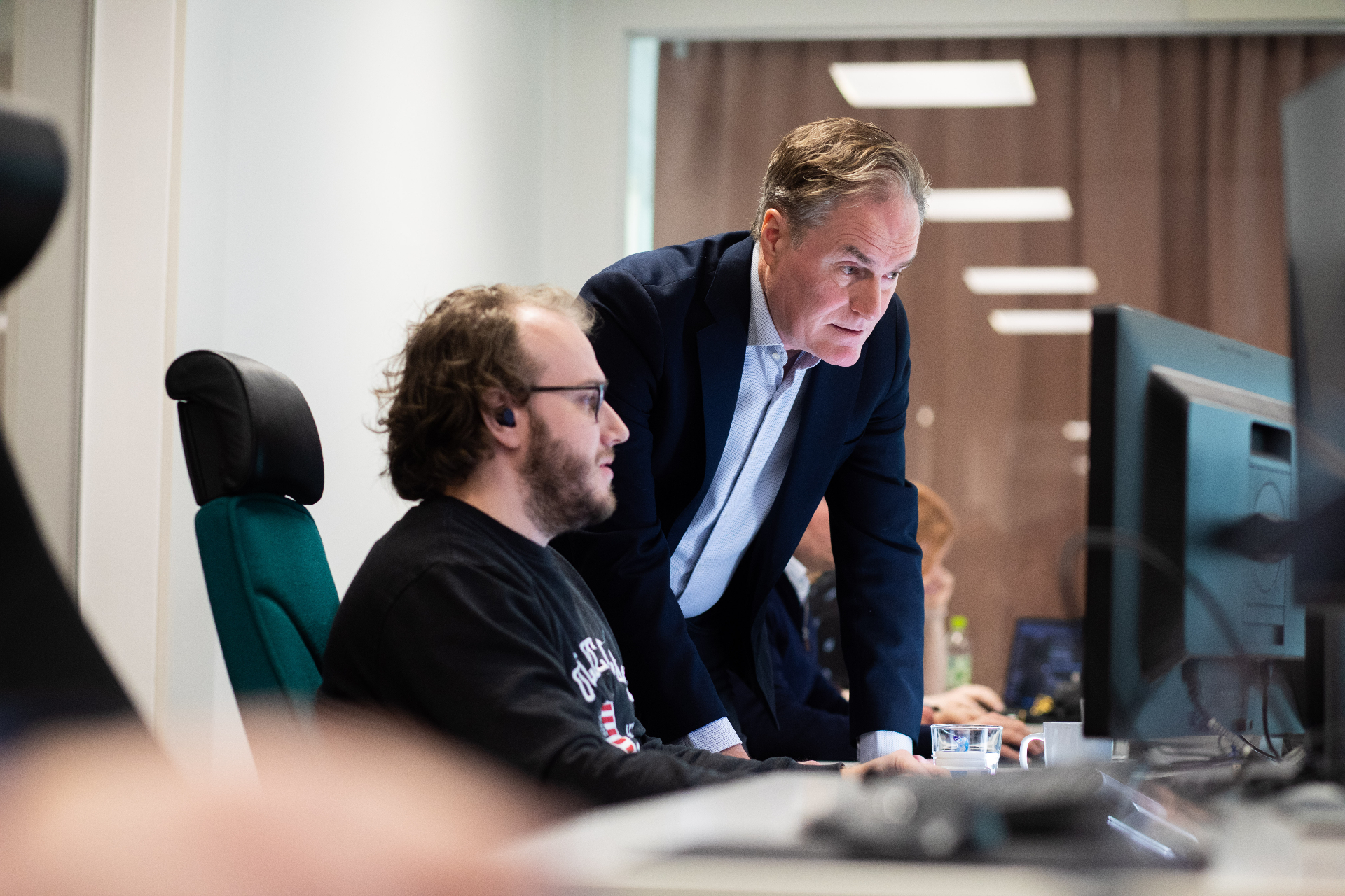 Two colleagues reviewing reports together